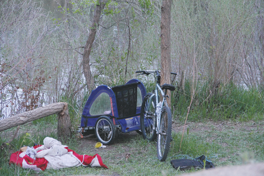 A bike and other belongings near a camp site on the Denver side of the South Platte River — Englewood is on the east side for a stretch— near West Dartmouth Avenue May 6. At least two people sat at the camp site that evening. One, a middle-aged man who has been homeless and camping on the river for four years, said the number of campers has more than doubled in the past two years. The man, who did not want to be named, has spent time along the river between West Mississippi to Quincy avenues. It stretches through Sheridan, Englewood and Denver in that distance.